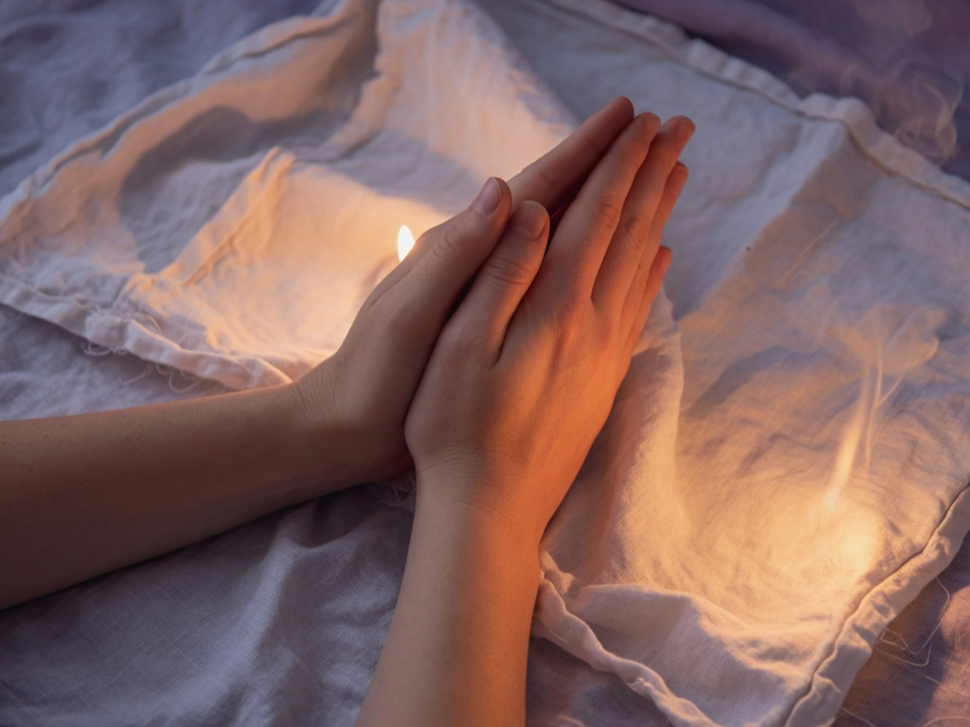Two hands clasped in prayer.